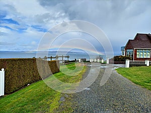 Red house by the rainbow sea shore