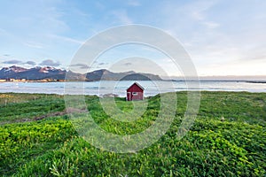 Red House on Ramberg beach in Lofoten island in Norway during sunset. photo