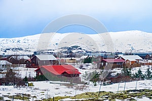 The red house in the snow-capped mountain in Iceland.