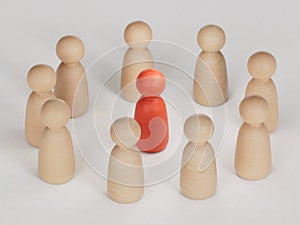 Red human figure surrounded by a circle of people. Leader Boss and leadership. Cooperation and teamwork.