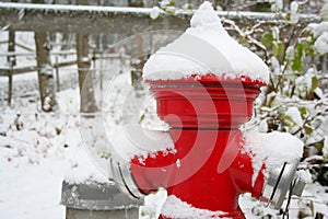 Red hydrant covered by snow