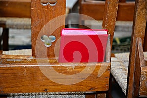 Red Hymn book on chair photo