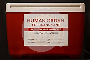 Red ice chest with label stating Human Organ for Transplant