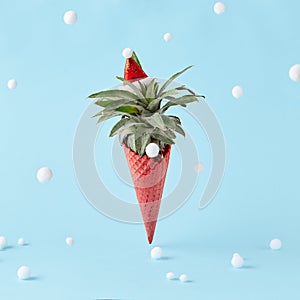 Red ice cream cone with pineapple on pastel blue background