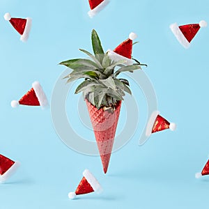 Red ice cream cone with pineapple on pastel blue background