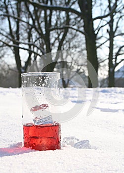 Red, icy drink in snow