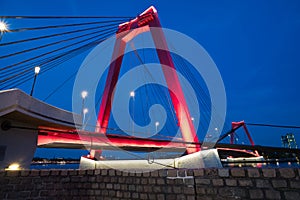 Red illuminated Willems Bridge in Rotterdam