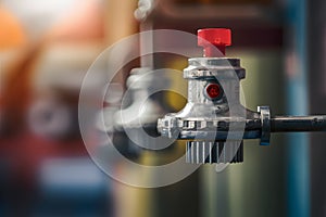 Red indicator fire sprinkler head on blurred background emphasizes safety and readiness photo