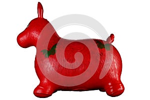 Red inflatable horse for jumping in the game room of the kindergarten isolated on black background