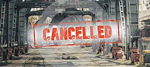 Red inscription cancelled on a blurred background  of railway wagons and cranes on production.