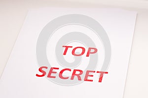 Red inscription TOP SECRET on a white sheet. Secrets and conspiracies. Archives of documents. Financial statements.