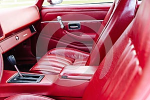 interior is made of red leather of old powerful classic American car