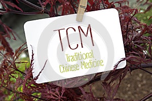 Red japanese maple with card board and TCM photo