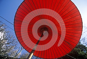 A red Japanese umbrella at the Engaku-Ji Zviroku-San Dai-Engaku Kosho Zen-Jin, a Zen Center, Kamakura, Little Old Kyoto, near