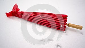 Red Japanese umbrella in snow
