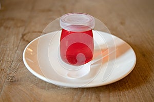 Red jellies in glass bottles.