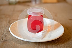 Red jellies in glass bottles.