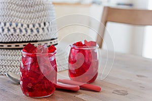 Red jelly, cut into dice, inside two glasses of glass