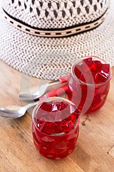 Red jelly, cut into dice, inside two glasses of glass