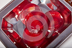 Red jelly strawberry and cherry candy on a metal plate macro