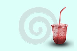 Red juice with ice in a plastic glass with clipping path