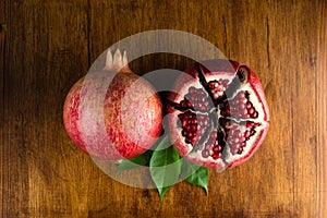 Red juicy pomegranate fruit on wooden table