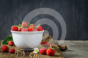 Red juicy strawberries in white bowl