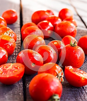 Red juicy tomatoes cherry on dark wooden board