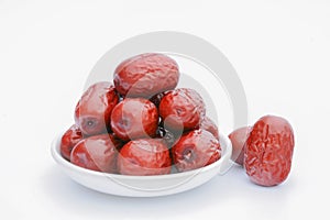 Red jujube with white dish on the white background