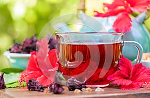 Red karkade hibiscus red sorrel tea in glass mug roselle flowers