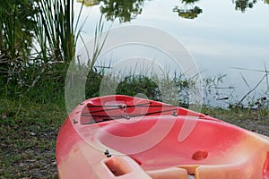 Red kayak pointed towards water