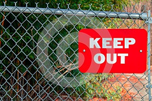 A Red Keep Out Sign on a Fance