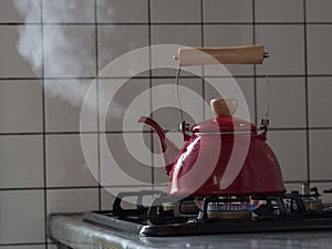 Red kettle steaming hot.