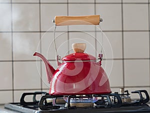 Red kettle steaming hot.
