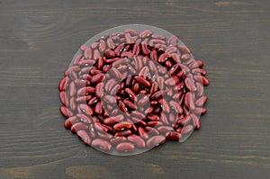 Red kidney beans on dark wooden background