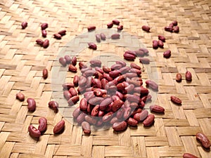 Red kidney beans or jogo Phaseolus vulgaris L. on woven bamboo background photo