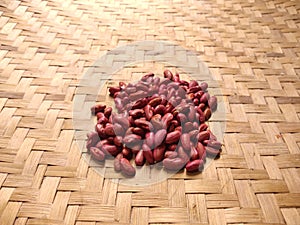 Red kidney beans or jogo Phaseolus vulgaris L. on woven bamboo background photo