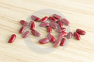 Red kidney beans on wooden background, top view, flat lay, top-down, selective focus.copy space