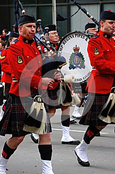 Red Kilted Bagpipe players