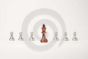 Red king chess in front of pawn chess on white background , Leadership concept