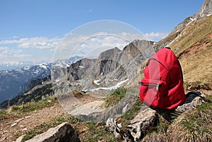 Red knapsack, against austrian mountain panorama