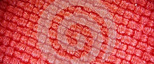 Red knitted fabric in a microscope