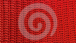 Red knitted wool fabric texture as background