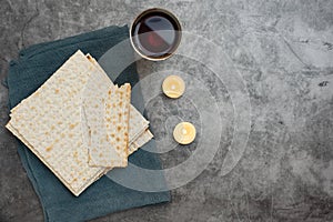 Red kosher wine with matza on a grey background. Top view. With copy space
