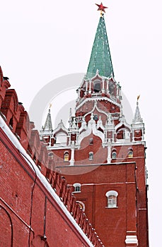 Red Kremlin wall and Troitskaya Tower in winter