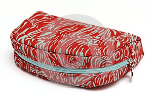 A red ladies pouch bag with white light colored stripes prints white backdrop