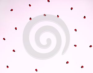 Red ladybugs on a pink background