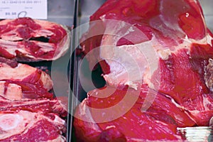Red lamb meat with veins on a store counter