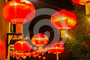 Red lantern as street lights hanging at a wall for Chinese New Year