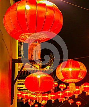 Red lantern as street lights hanging at a wall for Chinese New Year